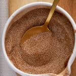 A white bowl of mixed cinnamon sugar ingredients.