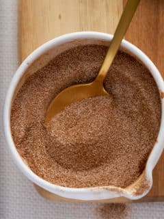 A white bowl of mixed cinnamon sugar ingredients.