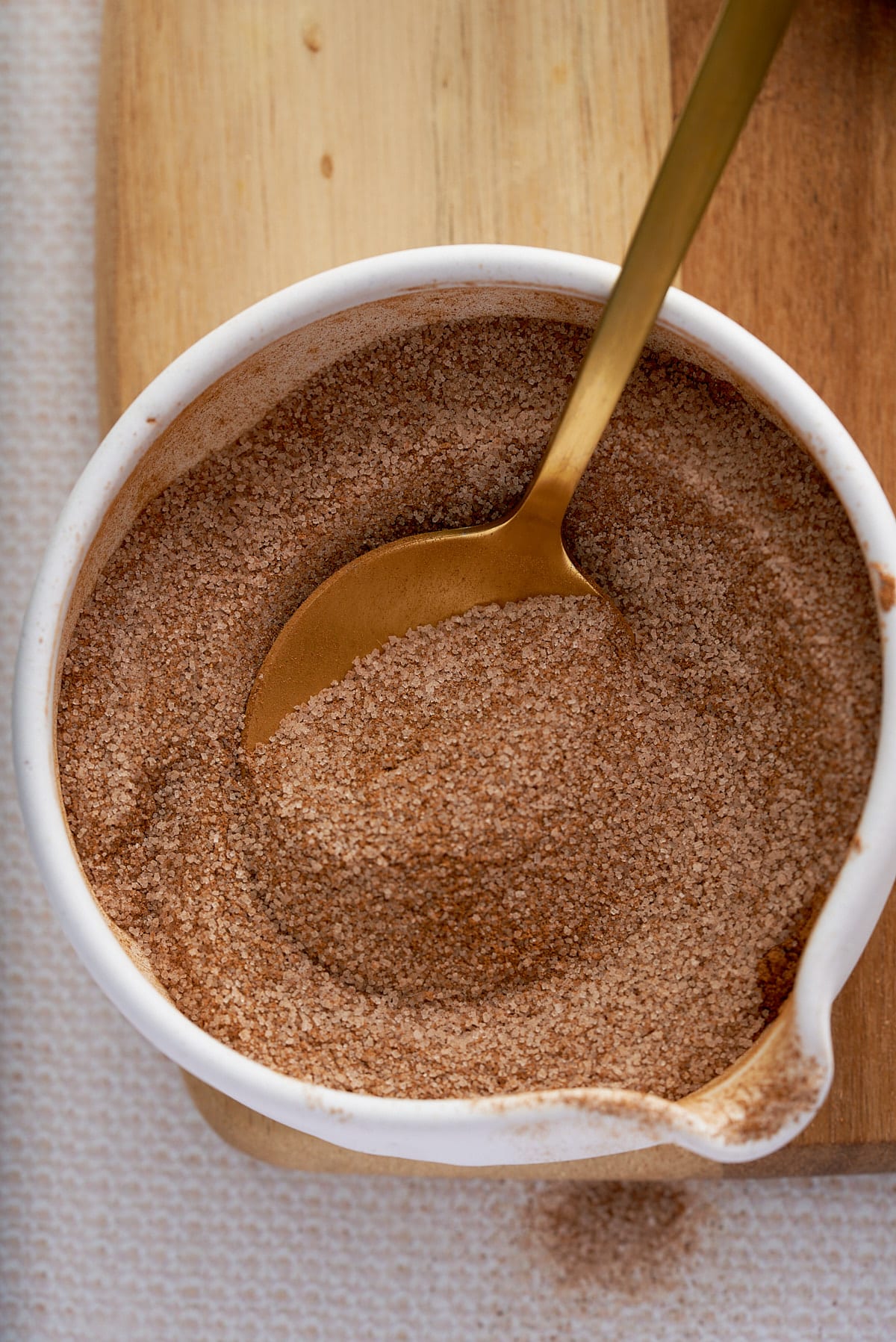 A white bowl of mixed cinnamon sugar ingredients.
