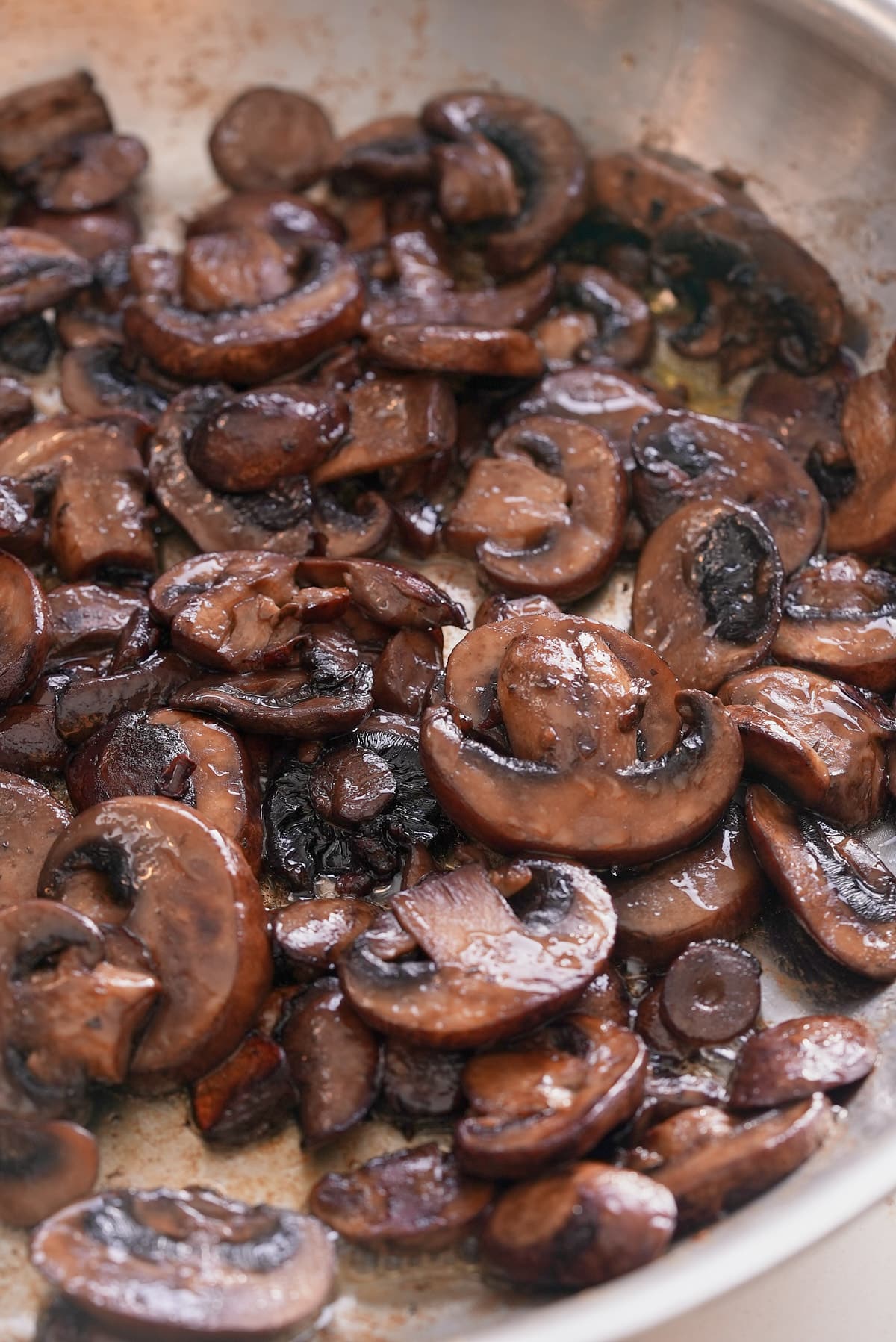 Sauteed mushrooms in a pan.