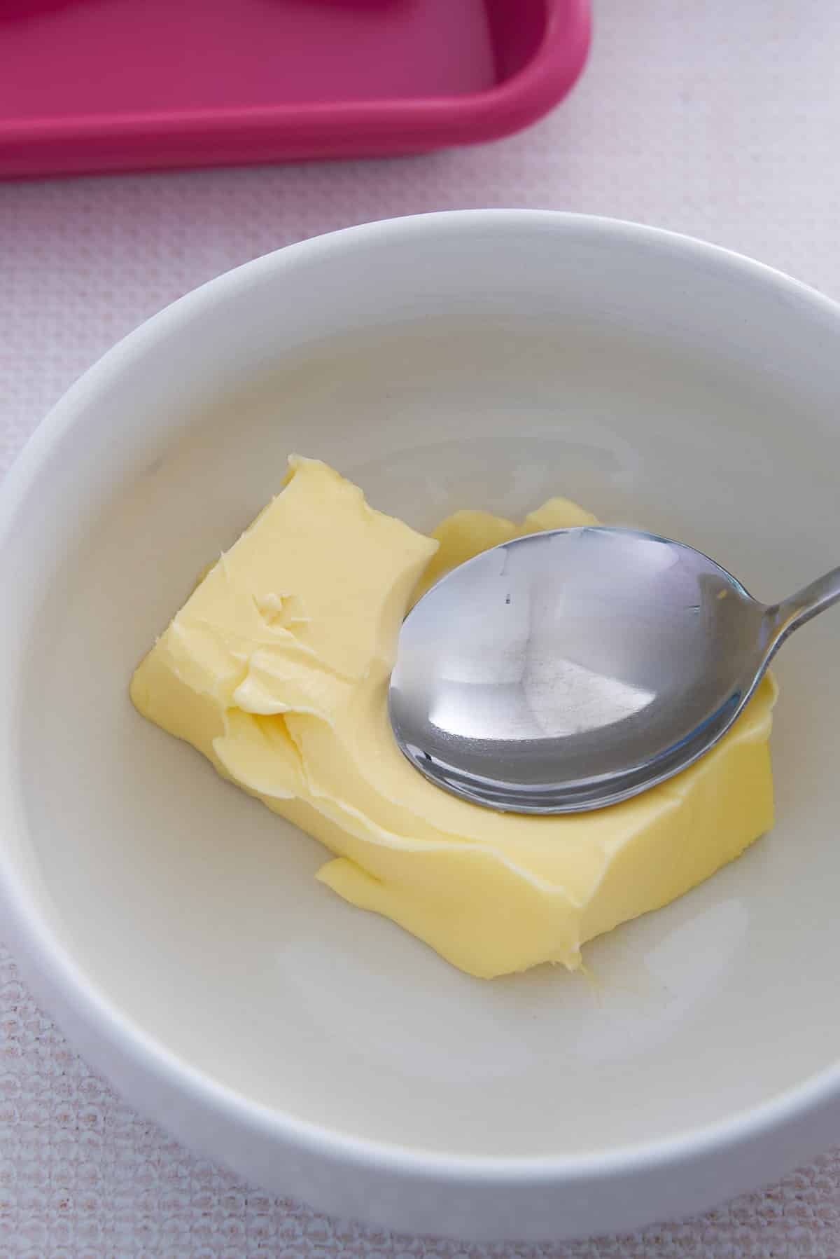 A white bowl of softened butter.