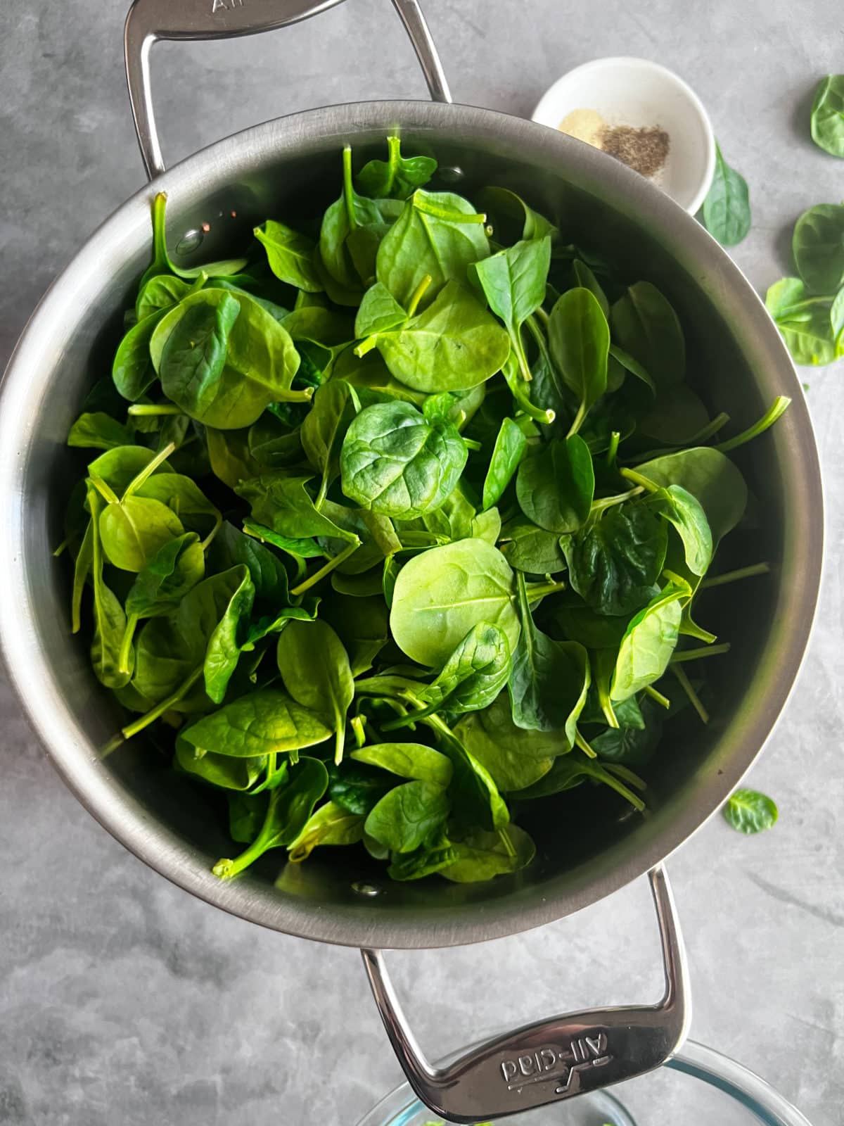 raw spinach in pot before cooking. 