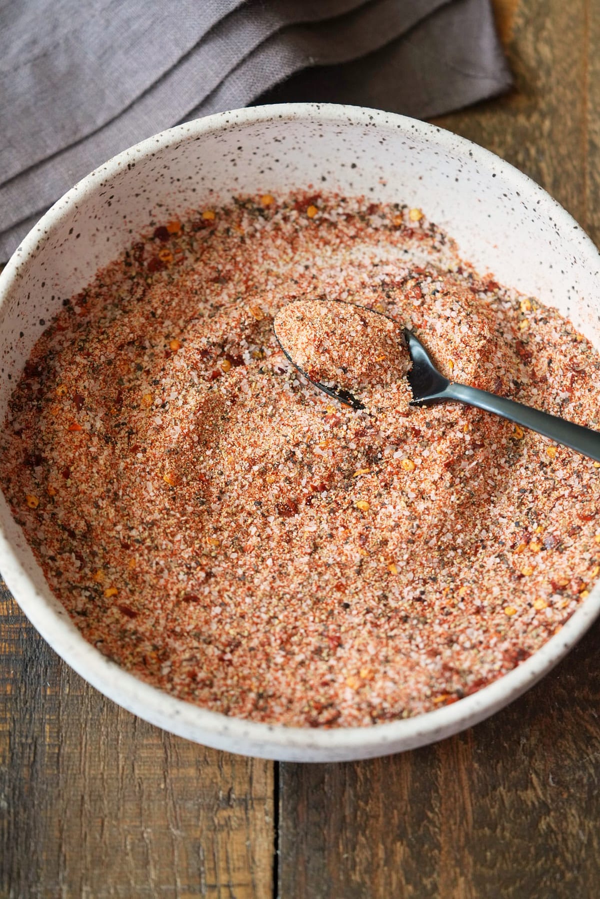 A bowl filled with steak seasoning.
