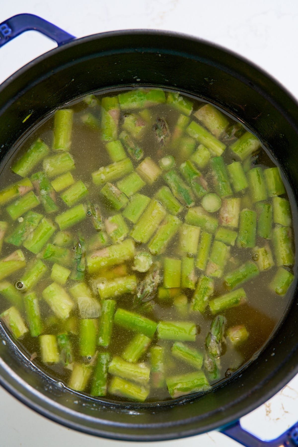 broth covering asparagus in pot
