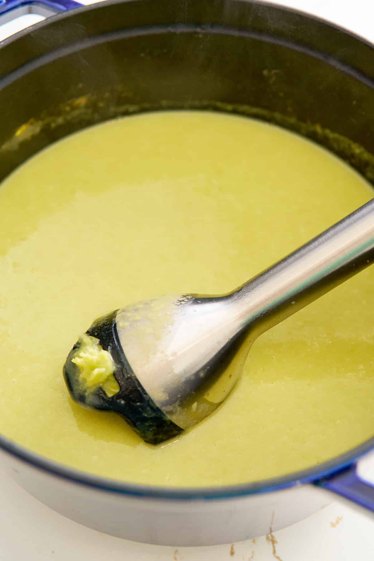 blender blending the asparagus soup in the pot