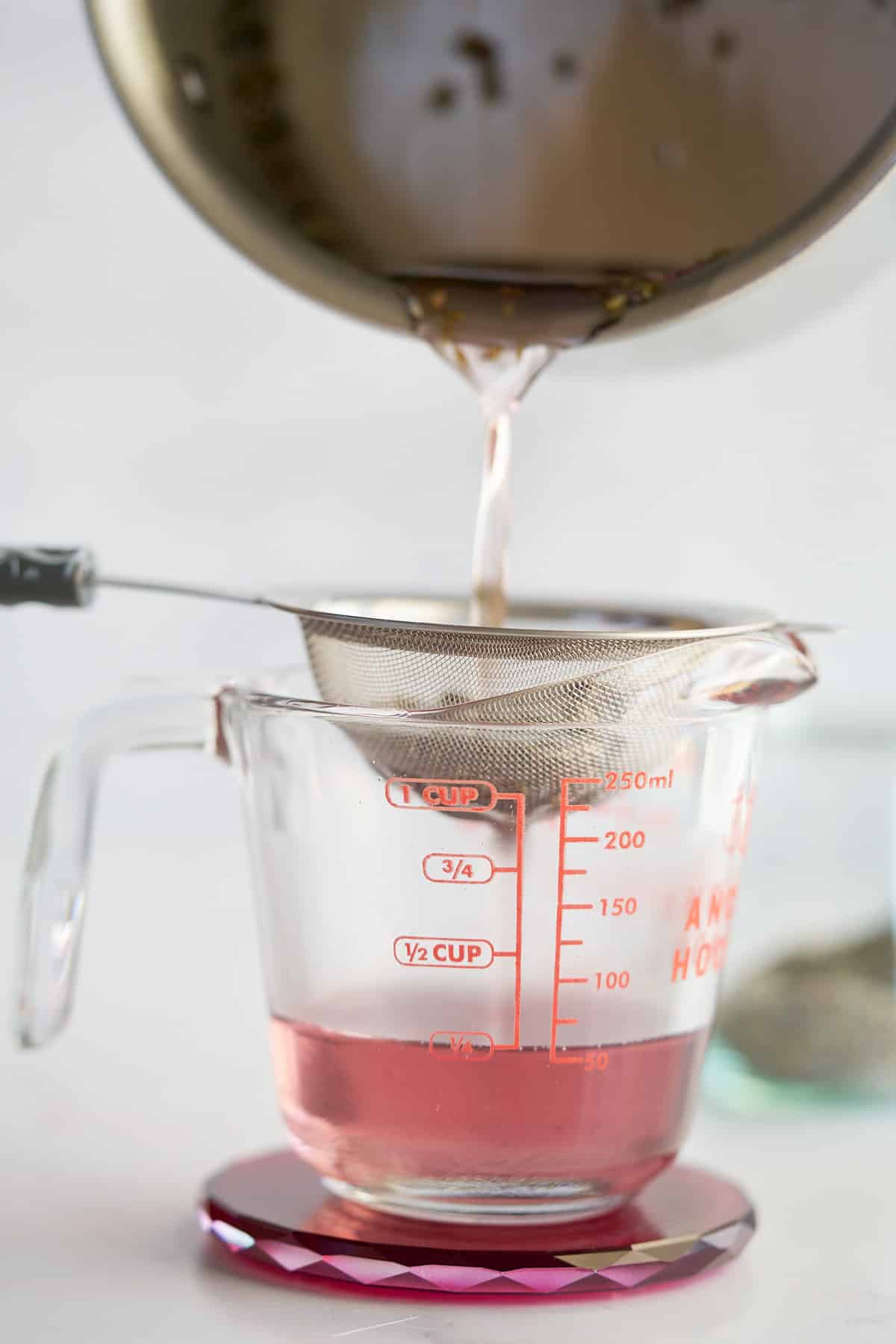 lavendersyrup being strained into cup