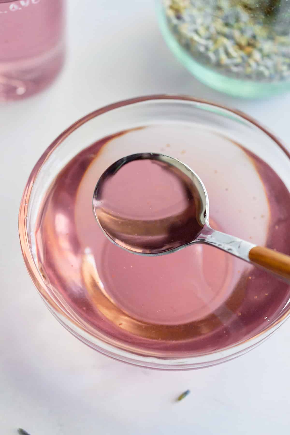 lavender simple syrup in a glass bowl