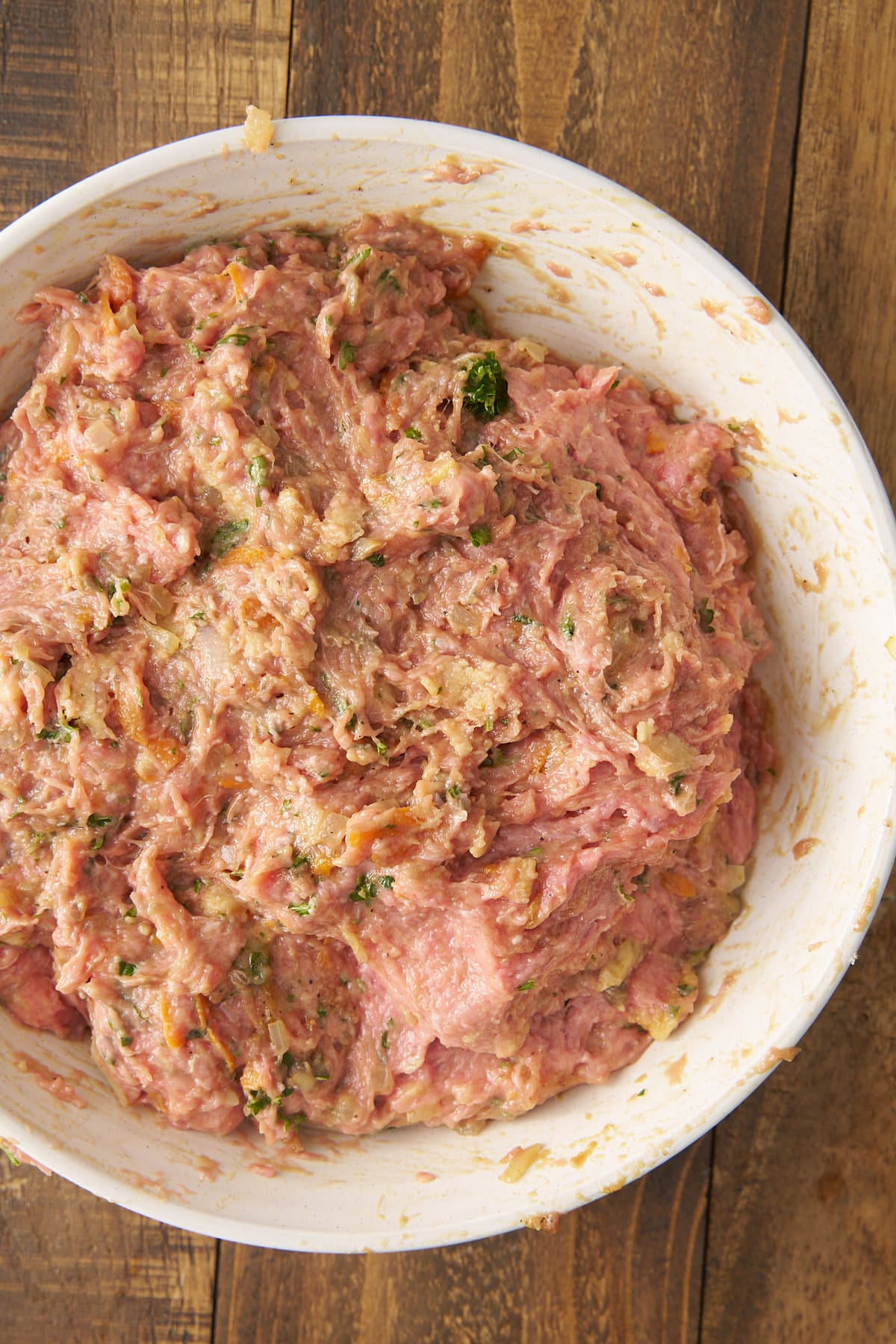 raw ground turkey with seasonings in bowl