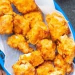 air fryer chicken nuggets in blue basket with parchment paper liner