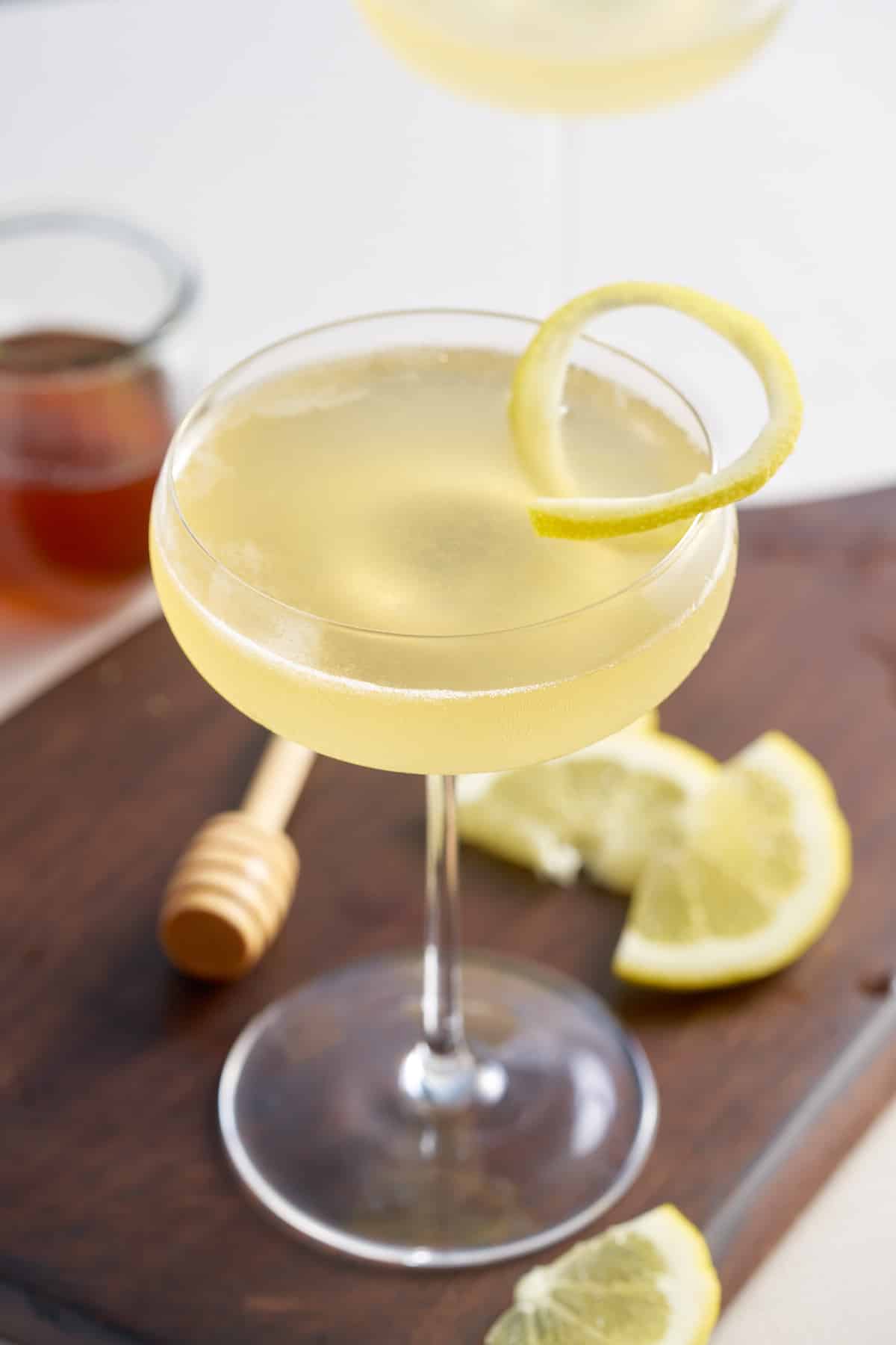 bees knees in coup glass on wooden board