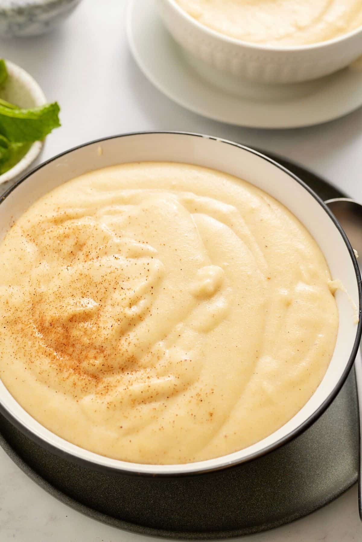 cornmeal porridge in bowl with spoon on side