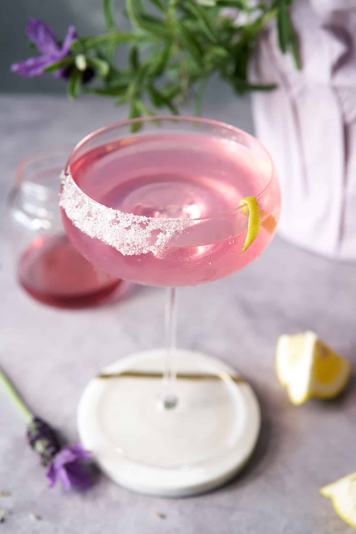 lavender martini in glass at upward angle