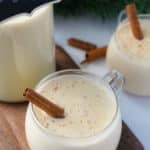 eggnog in glass with cinnamon stick sticking out