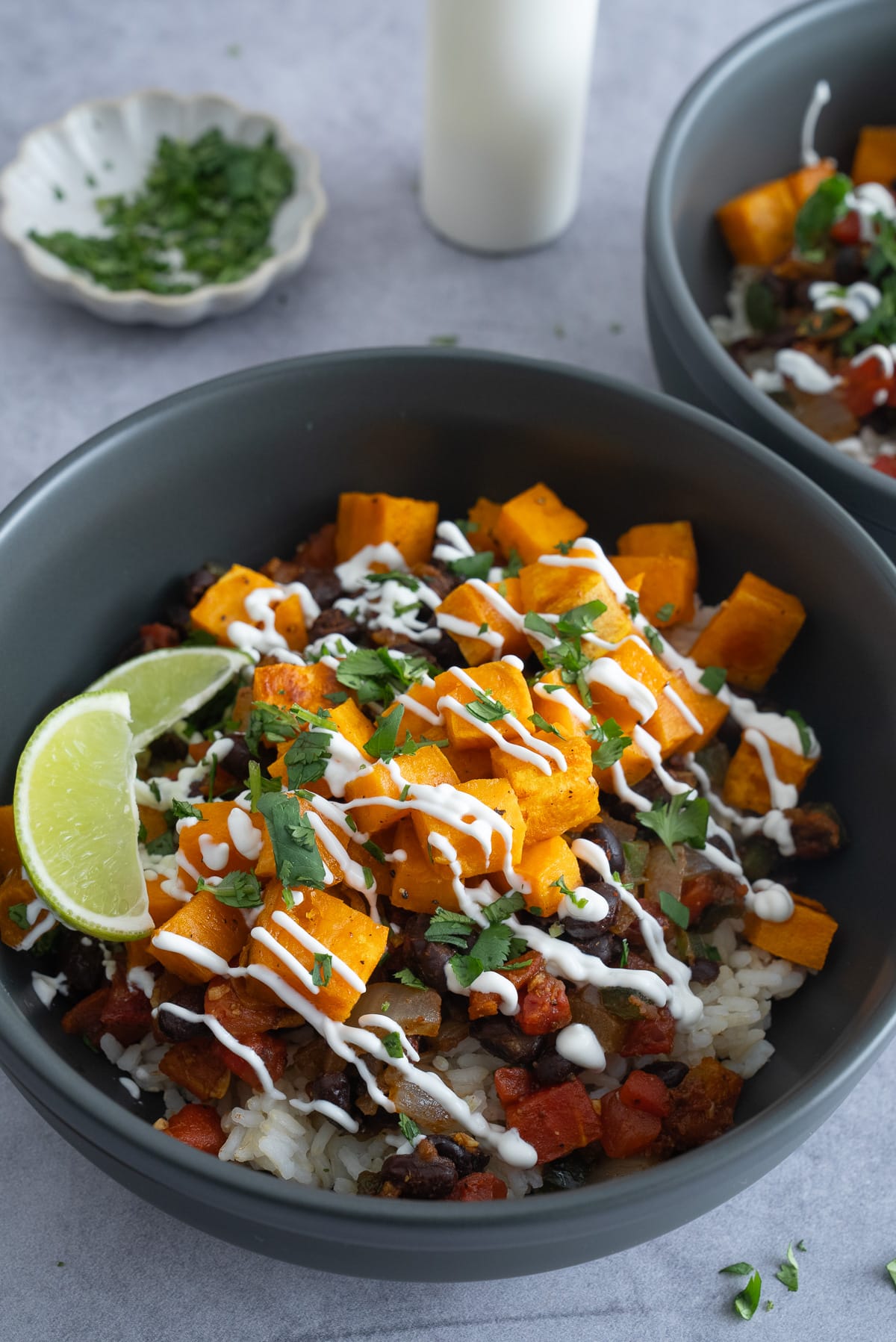 composed sweet potato bowl with sour cream drizzled on top
