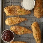 baked chicken tenders on rack with dipping sauces on the side