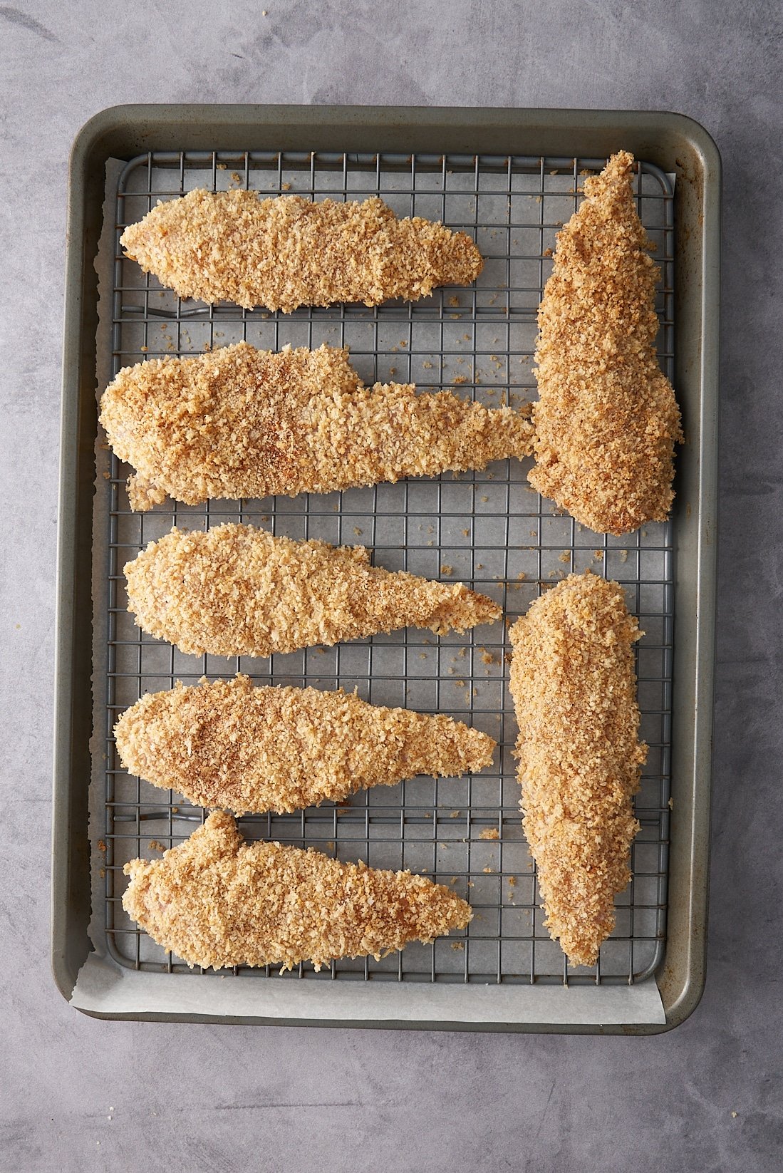 chicken tenders on rack before baking