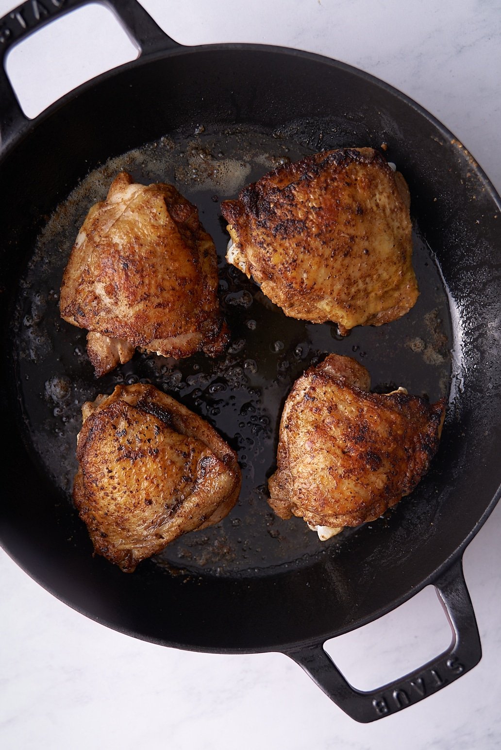 seared chicken thigs in skillet