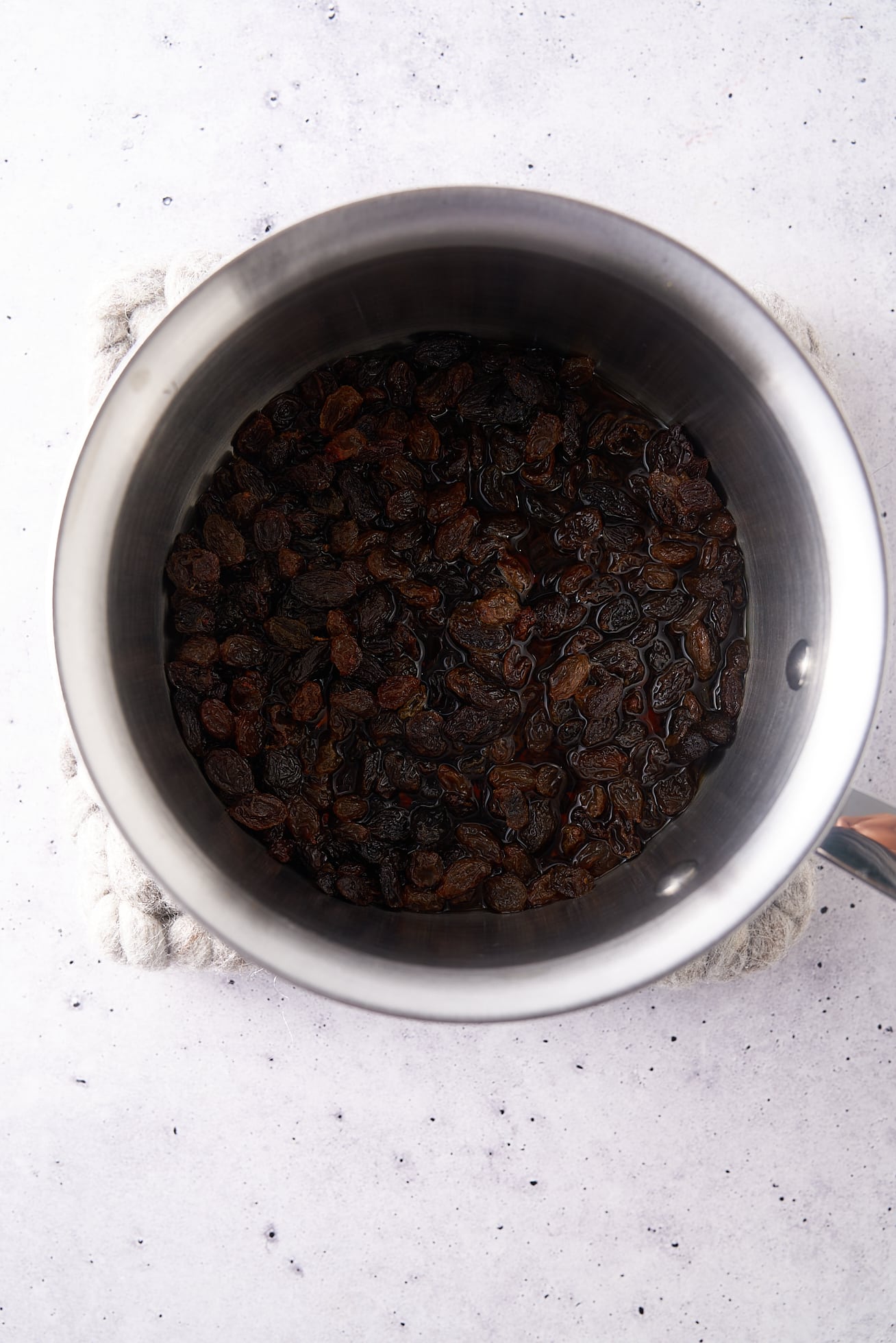 raisins soaking in rum in saucepan