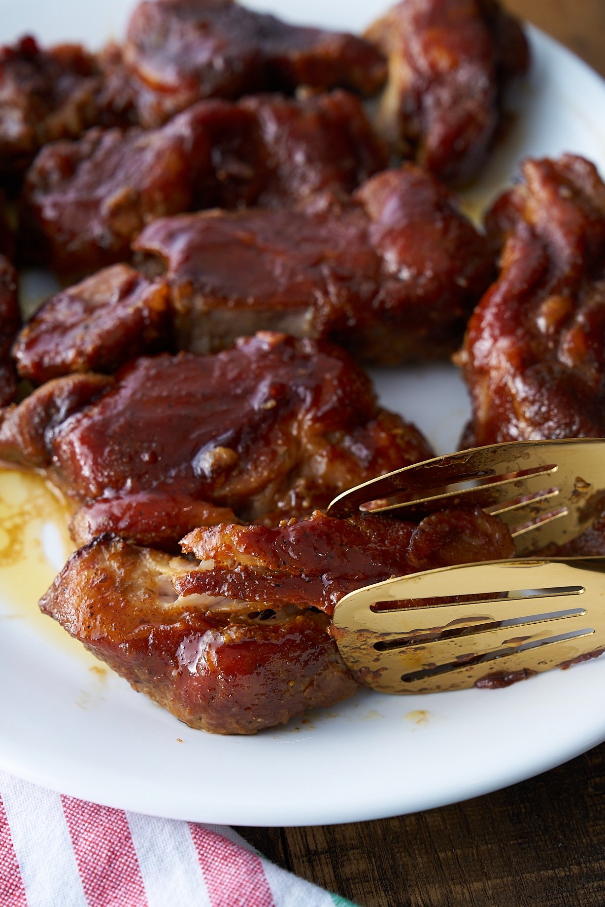 country style ribs being held with tongs