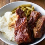 country style ribs on plate with mashed potatoes and green beans