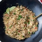overhead view of crab fried rice in wok with spoon in it
