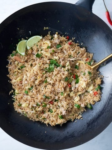 overhead view of crab fried rice in wok with spoon in it