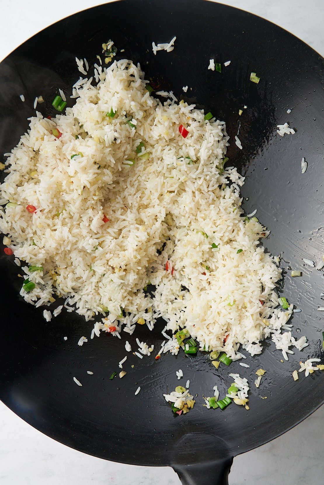 rice being stirfried in wok