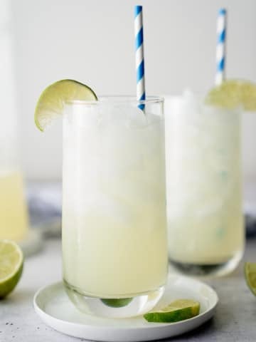 limemade in a glass with straw in it