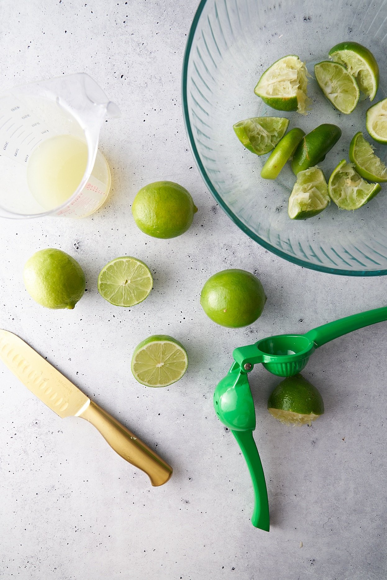 limes that have been squeezed and the rinds in a bowl