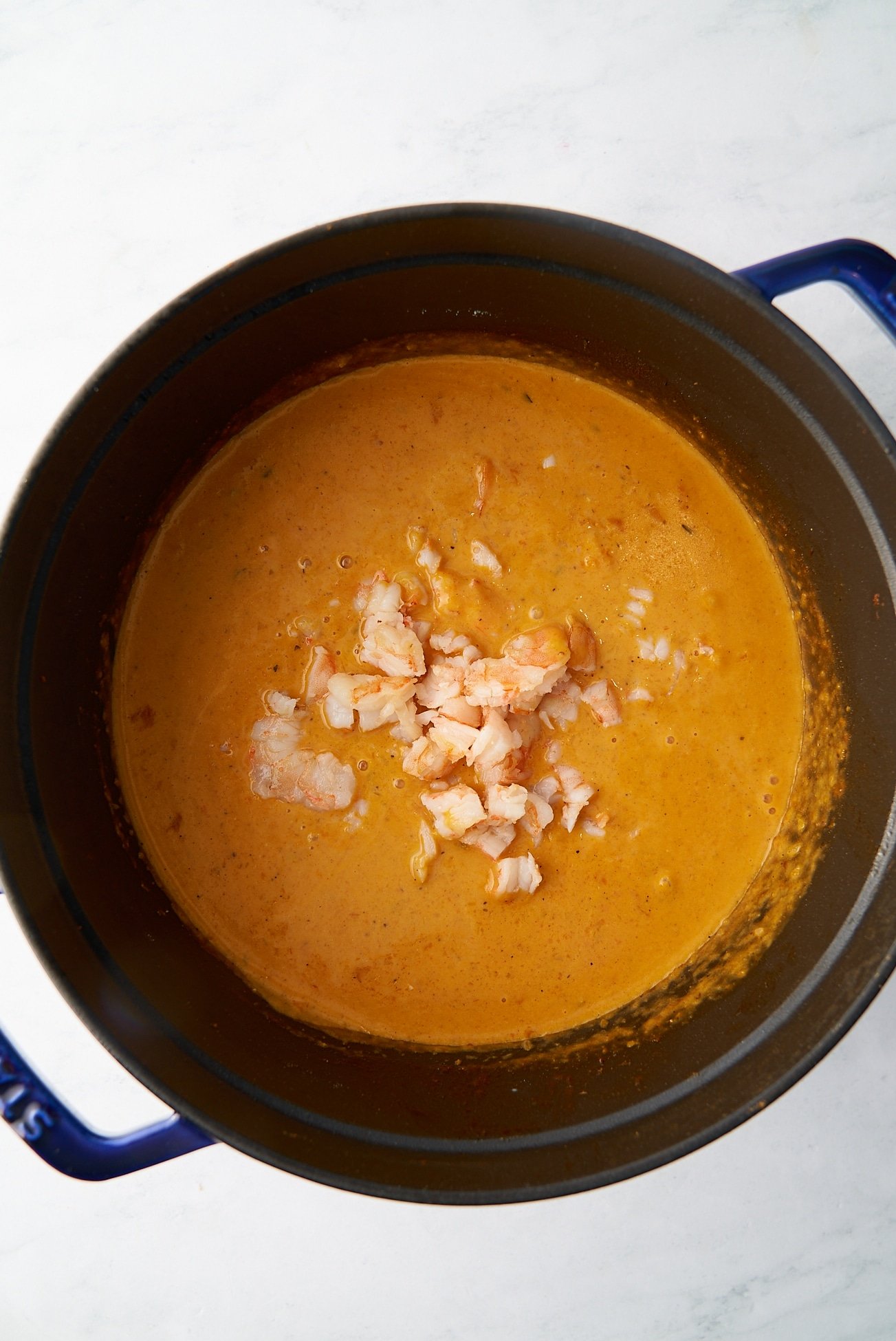 shrimp bisque with shrimp on top in pot