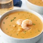 shrimp bisque in bowl with shrimp on top
