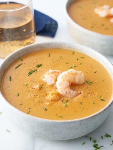 shrimp bisque in bowl with shrimp on top