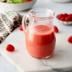 raspberry vinaigrette in a glass salad dressing bottle