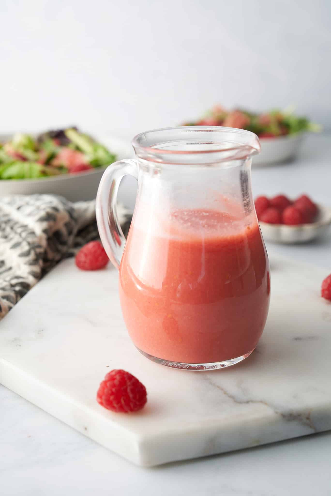 raspberry vinaigrette in a glass salad dressing bottle