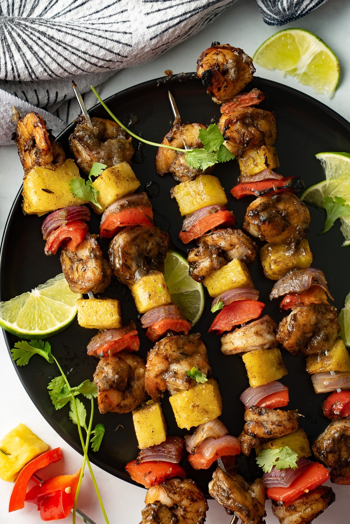 jerk shrimp skewers on black plate