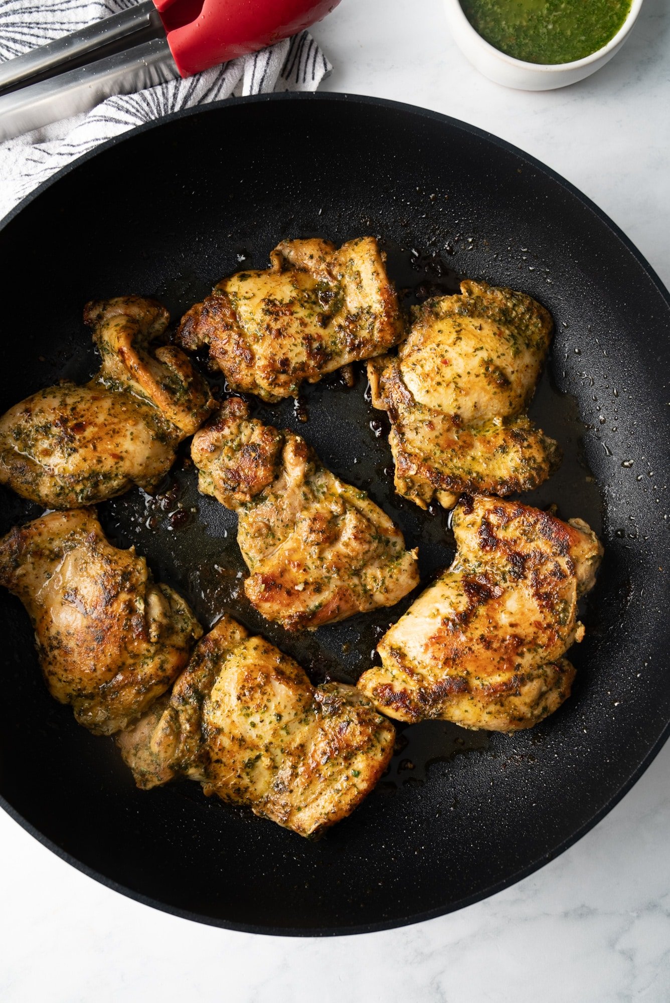 chicken being grilled in pan