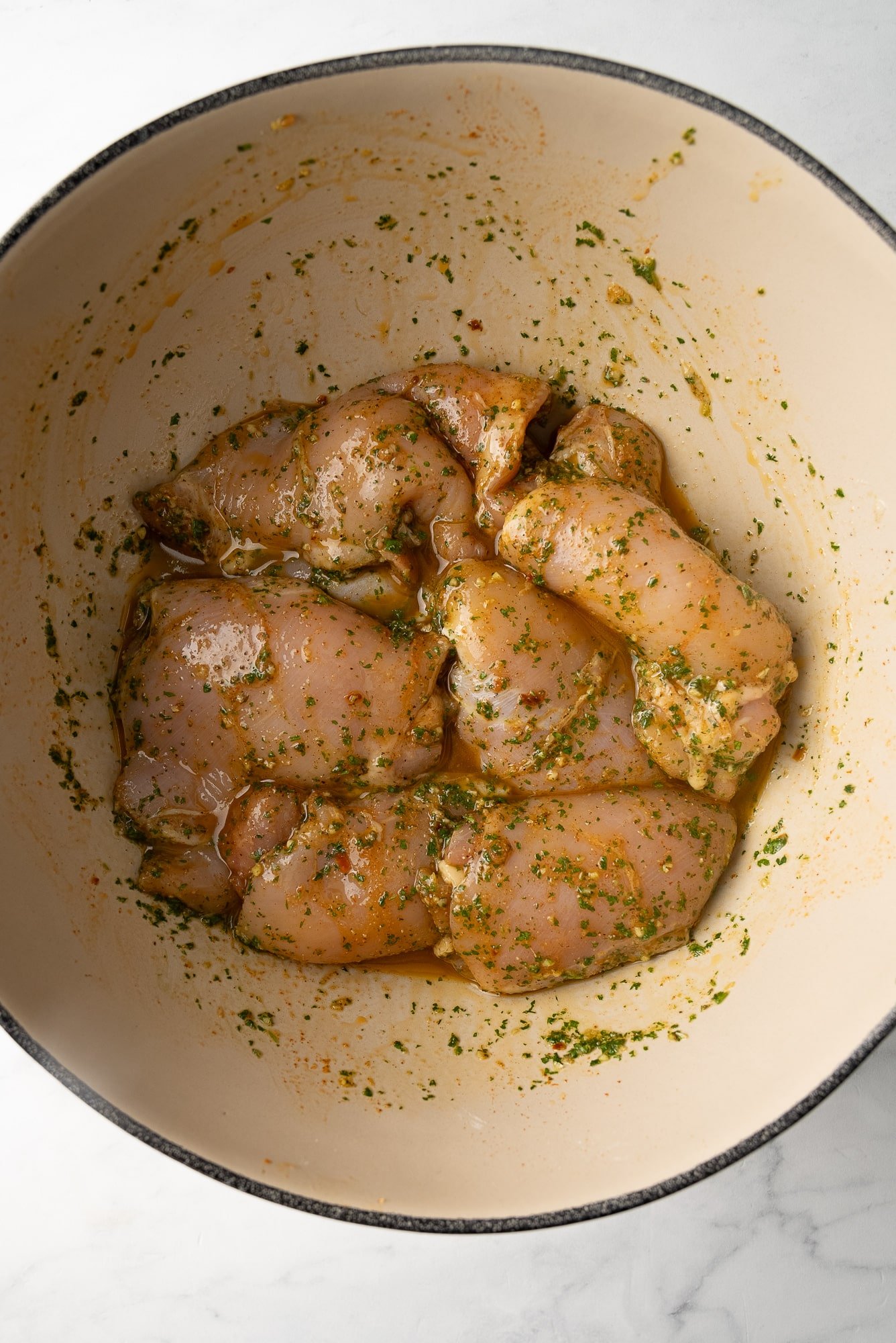 chicken in marinade in bowl