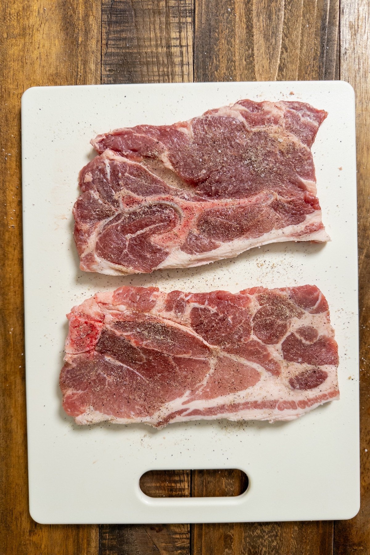 raw pork steak seasoned