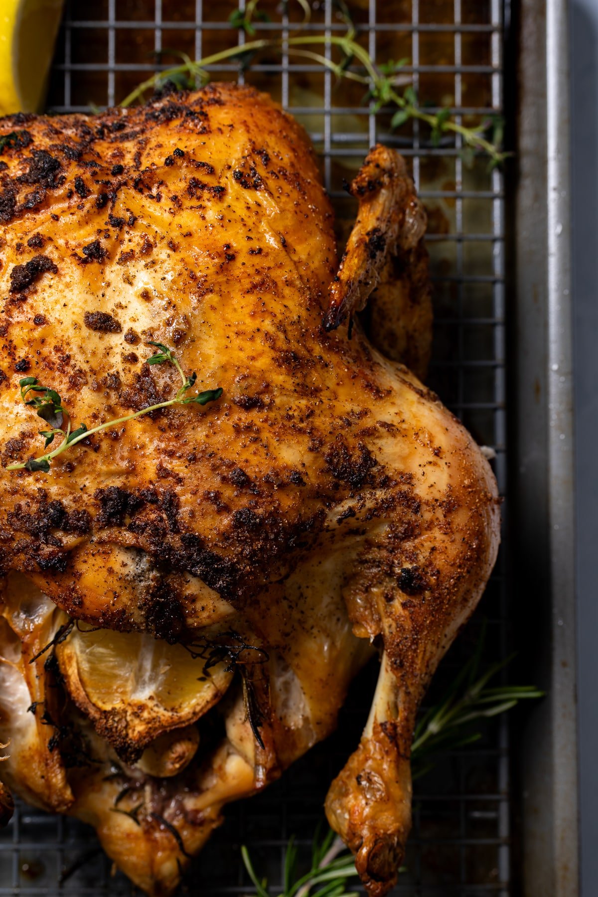 close up for whole roasted chicken on sheet pan with rack