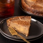Jamaican sweet potato pudding on plate with fork next to it