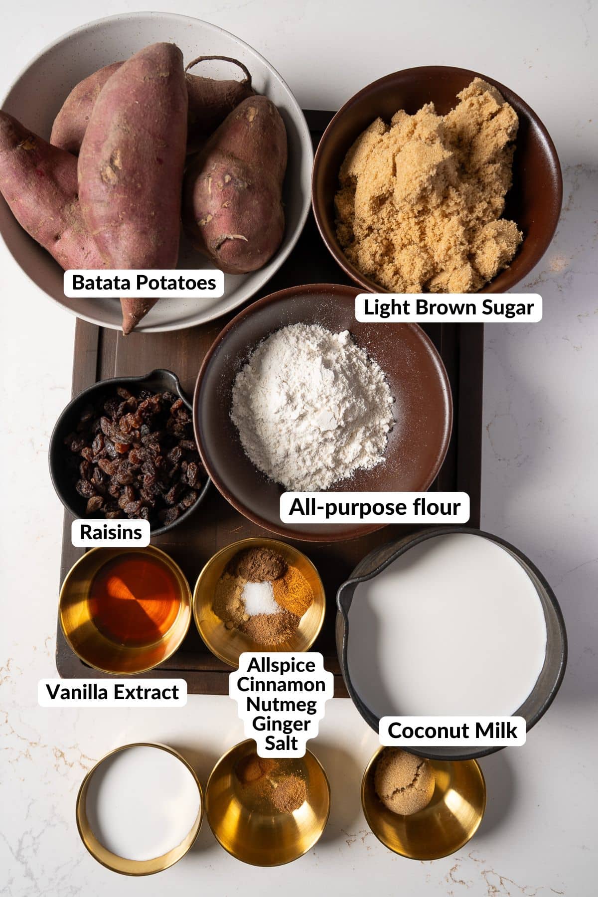 ingredients for the sweet potato pudding on a table with labels