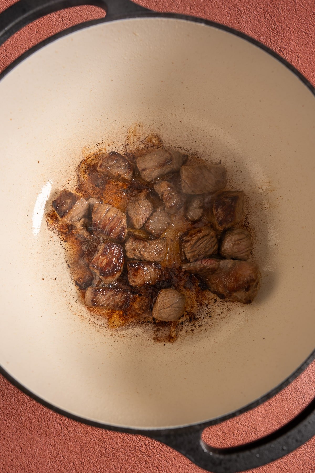 beef stew meat browning in pot