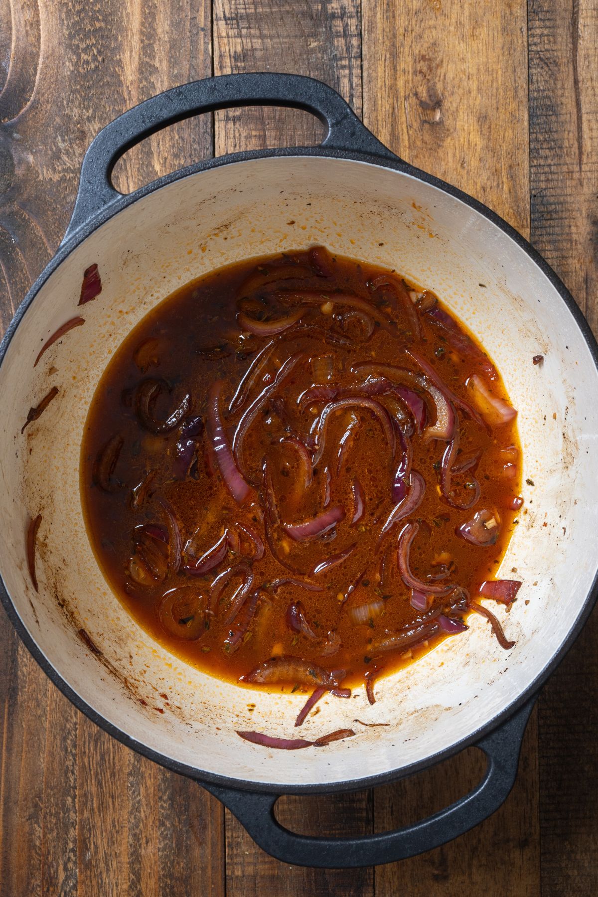 onions covered in broth in pot