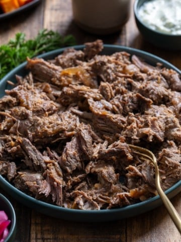 braised lamb on blue plate shredded