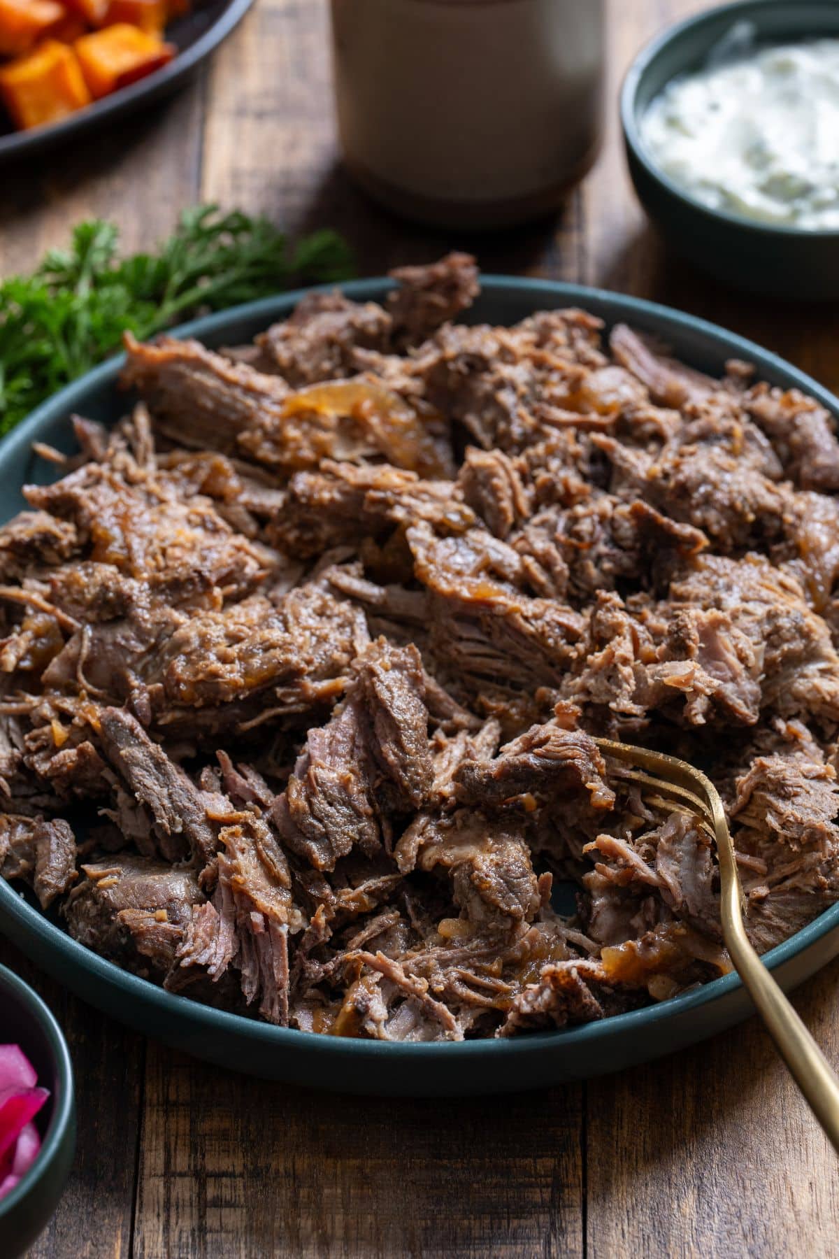 braised lamb on blue plate shredded