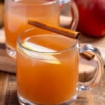 two glasses of homemade apple cider in mugs