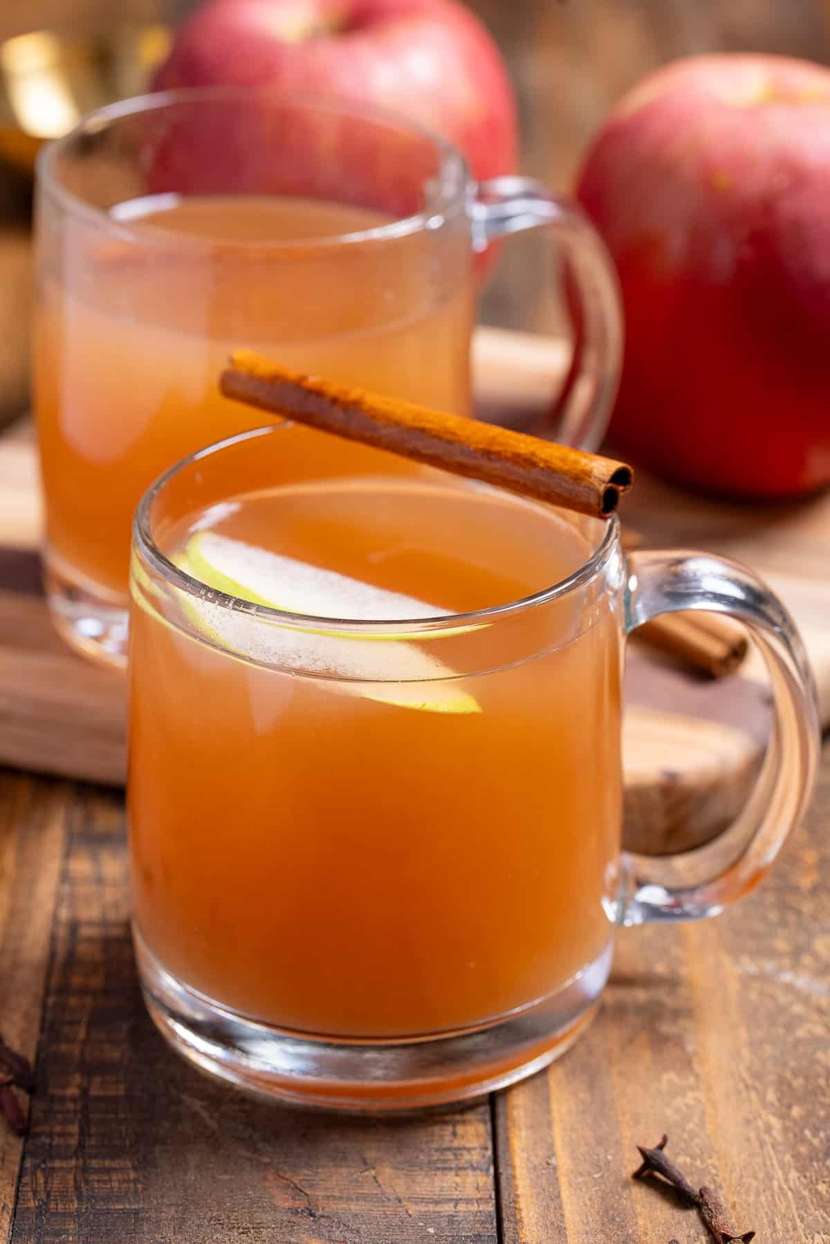two glasses of homemade apple cider in mugs