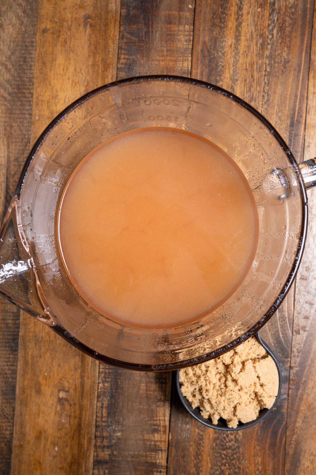 strained apple cider in glass container