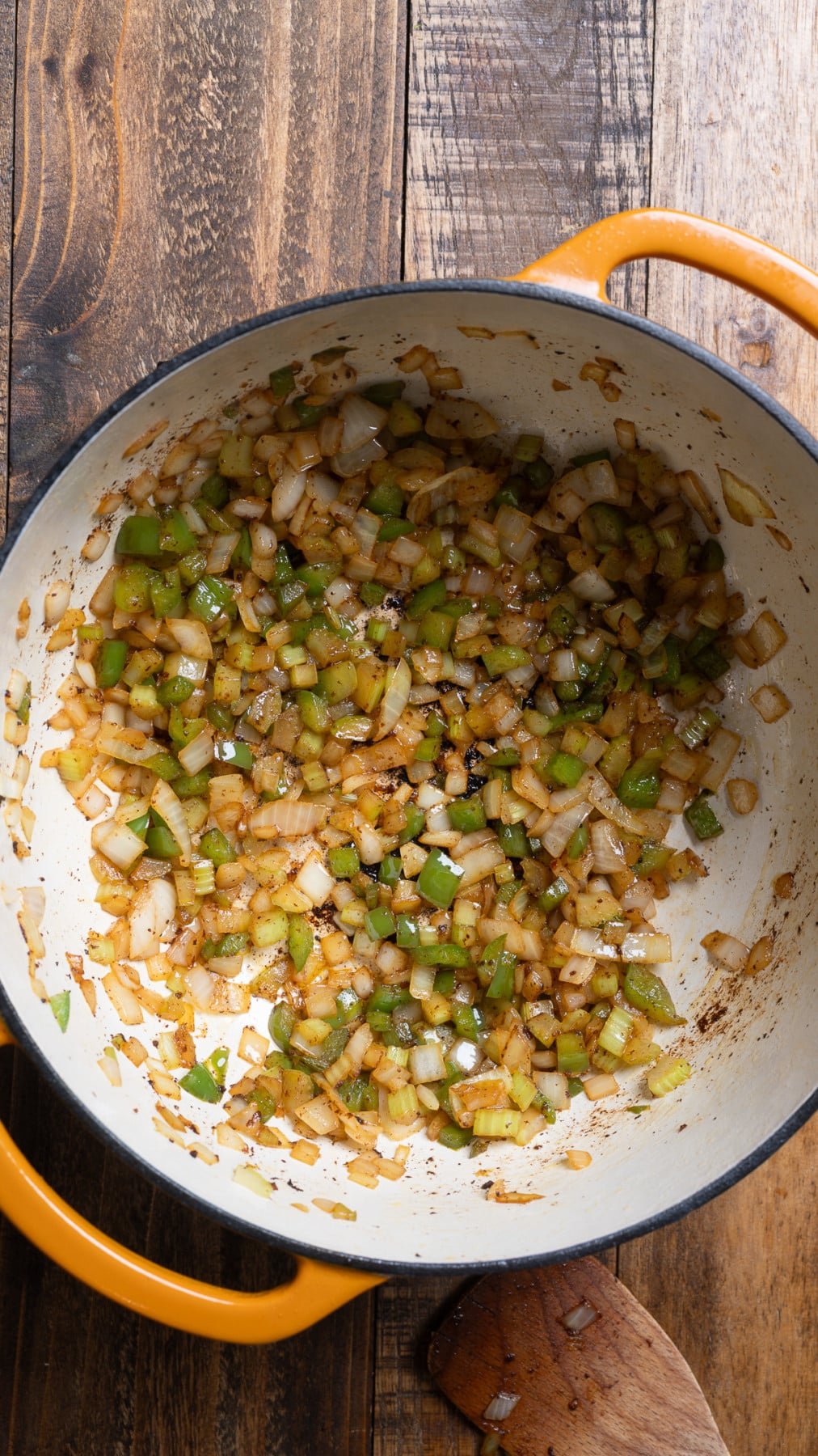 onion, bell pepper, celery, and garlic in pot cooking