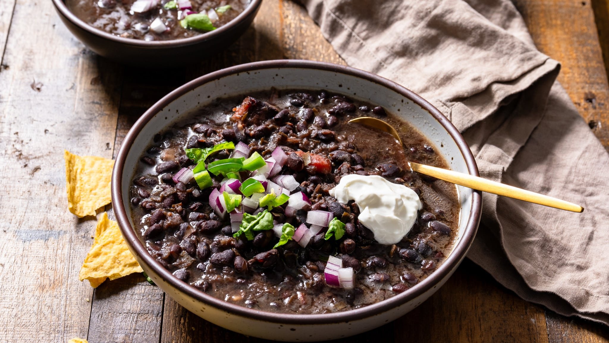 black bean soup in bowl with linen on side